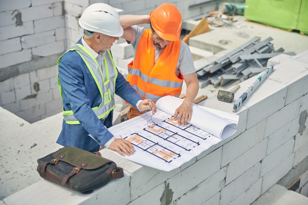 civil-engineer-looking-at-a-puzzled-male-worker-2021-09-03-21-02-29-utc